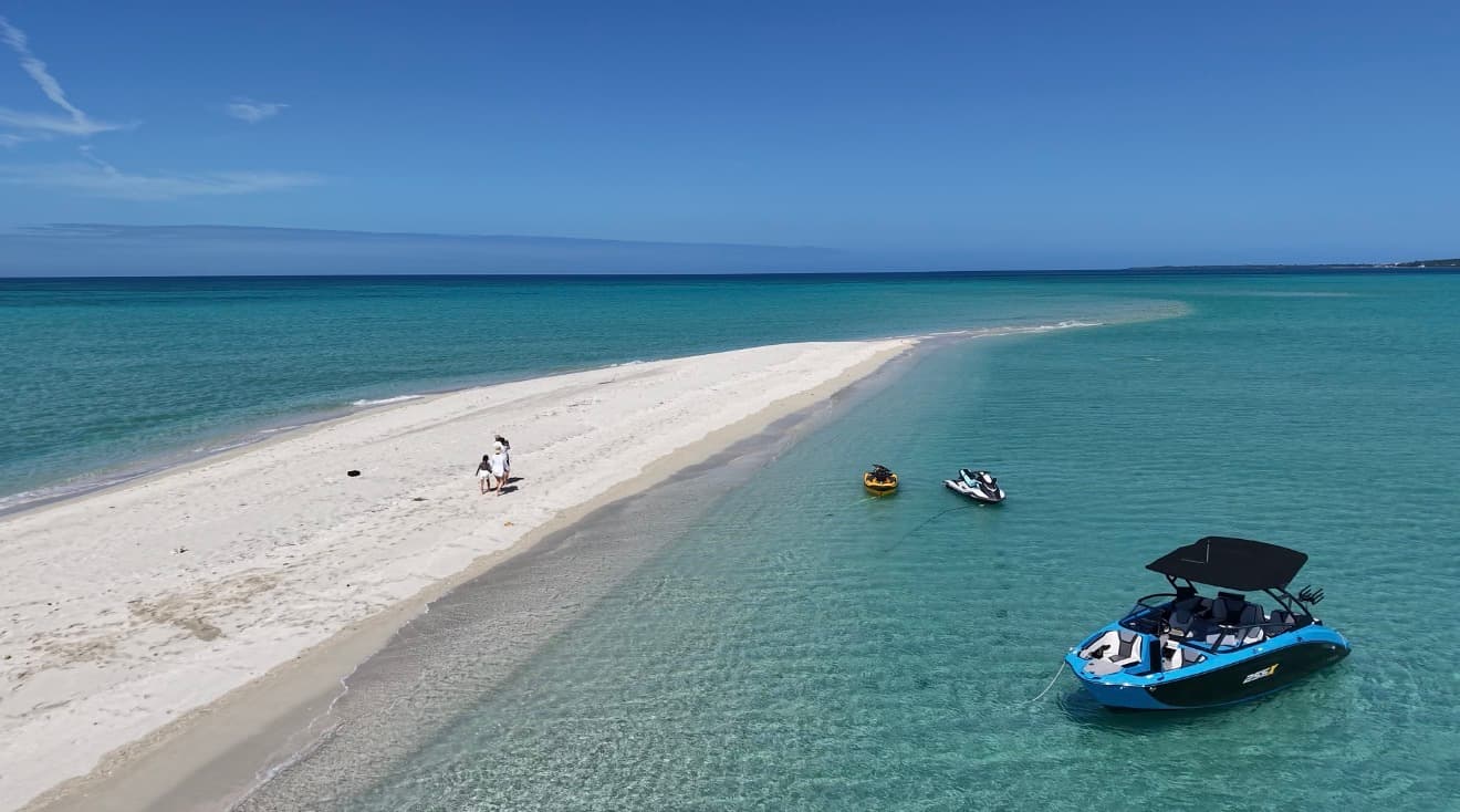 Boat charter in Miyako Island - Aerial view of boat and jet skis near a stunning white sandbar with crystal clear turquoise waters