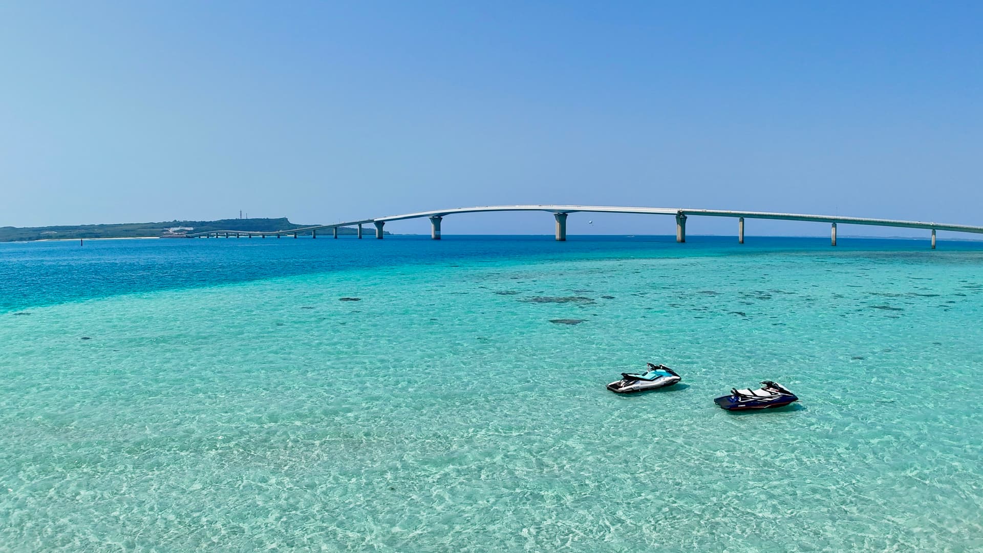 Jet ski rental in Miyako Island - Jet skis floating on crystal clear Miyako blue waters with Irabu Bridge in the background